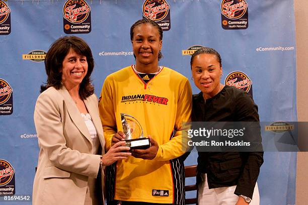 President Donna Orender and WNBA legend Dawn Staley present Tamika Catchings of the Indiana Fever with the "Dawn Staley Community Leadership Award"...
