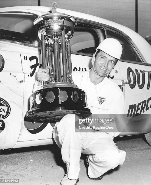 Tim Flock holds the Sports Illustrated NASCAR Cup Series championship trophy, which he earned in 1955. Flock drove the Karl Kiekhaefer Chrysler...