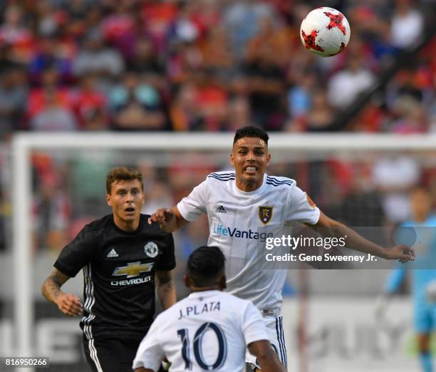 Luis Silva of Real Salt Lake heads the ball to teammate Joao Plata in the first half of their game against Manchester United during the International...