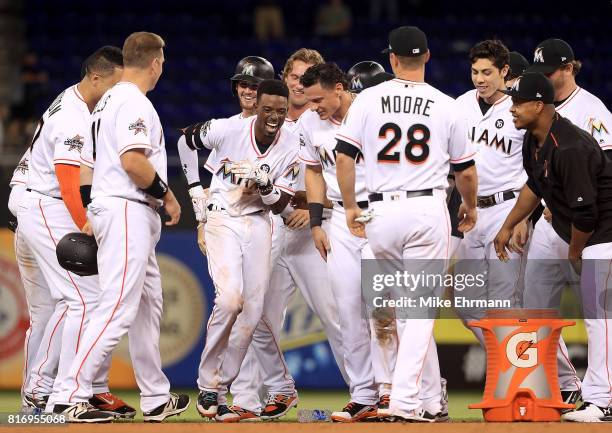 Dee Gordon of the Miami Marlins celebrates hitting a bases loaded walk off single in the 11th inning during a game against the Philadelphia Phillies...