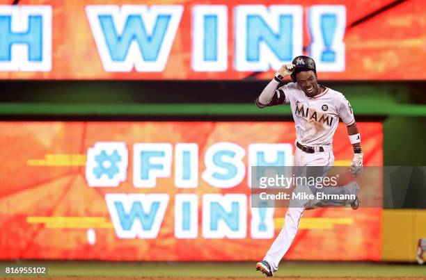 Dee Gordon of the Miami Marlins celebrates hitting a bases loaded walk off single in the 11th inning during a game against the Philadelphia Phillies...