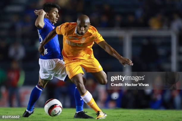 Angel Mena of Cruz Azul struggles for the ball with Yacine Brahimi of Porto during a match between Cruz Azul and Porto as part of Super Copa Tecate...