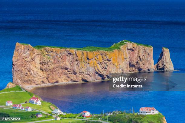 a look at the small town of percé and its famous rocher percé (perce rock), part of gaspe peninsula in québec. - perce rock stock pictures, royalty-free photos & images