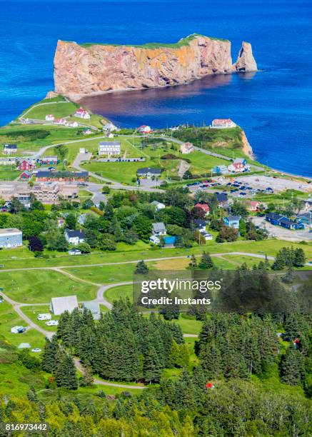 a look at the small town of percé and its famous rocher percé (perce rock), part of gaspe peninsula in québec. - perce rock stock pictures, royalty-free photos & images