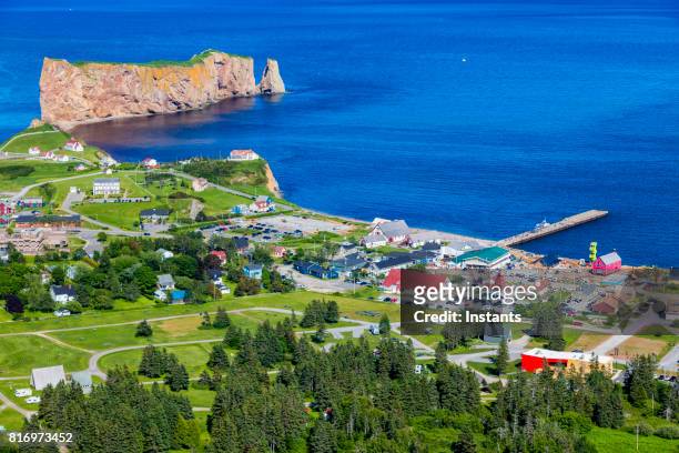 a look at the small town of percé and its famous rocher percé (perce rock), part of gaspe peninsula in québec. - gaspe peninsula stock pictures, royalty-free photos & images