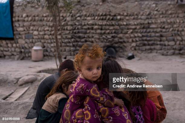 Children of families displaced by the Islamic State of Iraq and Syria -Khorasan play at their current home on July 14 in Surkh Rod District,...