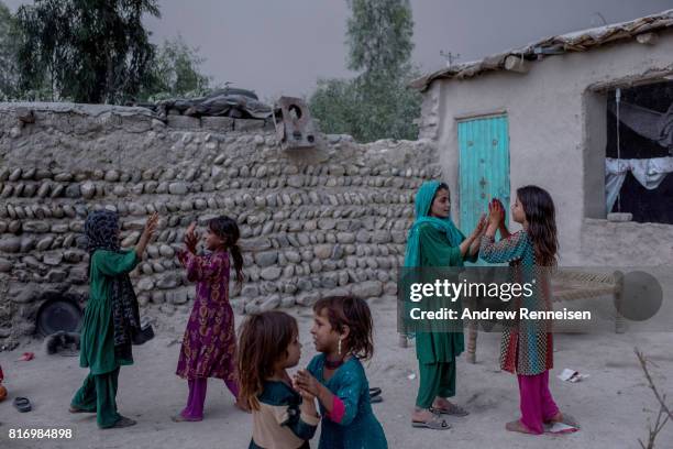 Children of families displaced by the Islamic State of Iraq and Syria -Khorasan play at their current home on July 14 in Surkh Rod District,...