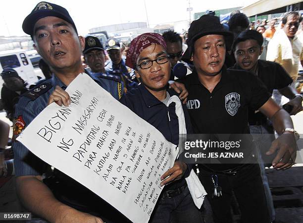 Levi Padua , a distraught relative of missing passengers of the sunken ferry MV Princess of the Stars, is escorted by police after being talked down...