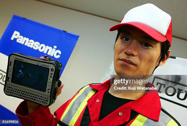 Model holds Matsushita Co Ltd's Panasonic new notebook computer "Toughbook CF-U1" at World Trade Center Building on June 25, 2008 in Tokyo, Japan.The...