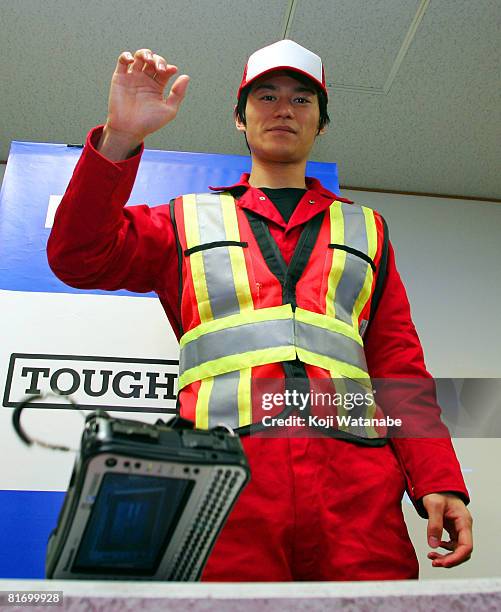 Model demonstrates the durability of Matsushita Co Ltd's Panasonic new notebook computer "Toughbook CF-U1" by dropping it from 120cm high at World...