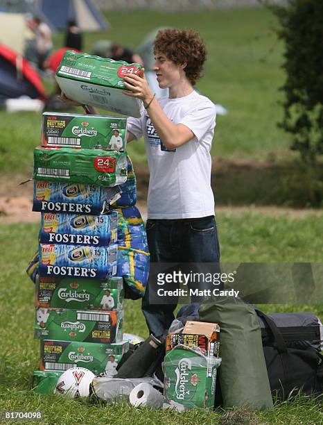 One of the first festival revellers arrives carrying supplies of beer at the Glastonbury Festival at Worthy Farm, Pilton on June 25, 2008 in...