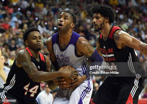 Vander Blue a#1 of the Los Angeles Lakers tries to drive between Antonius Cleveland and Jarnell Stokes of the Portland Trail Blazers during the...