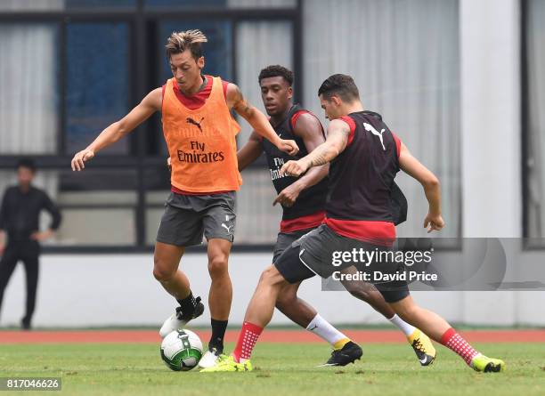 Mesut Ozil, Alex Iwobi and Granit Xhaka of Arsenal during an Arsenal Training Session at Yuanshen Sports Centre Stadium on July 18, 2017 in Shanghai,...