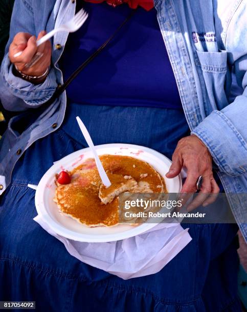 Customer enjoys his breakfast at an annual Fourth of July 'Pancakes on the Plaza' Rotary Club fundraising event in Santa Fe, New Mexico.