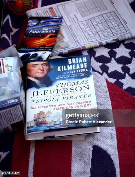 Copy of the book 'Thomas Jefferson and the Tripoli Pirates' by Brian Kilmeade sits on the seat of a classic car at a Fourth of July celebration in...