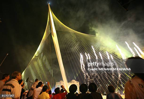 Israelis watch fireworkds during the inauguration ceremony of the 'Chords Bridge' , designed by Spanish architect Santiago Calatrava, at the main...