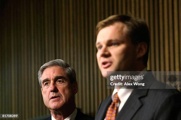 Acting Assistant Attorney General for the Criminal Division Matt Friedrich speaks as FBI Director Robert Mueller listens during a news conference at...