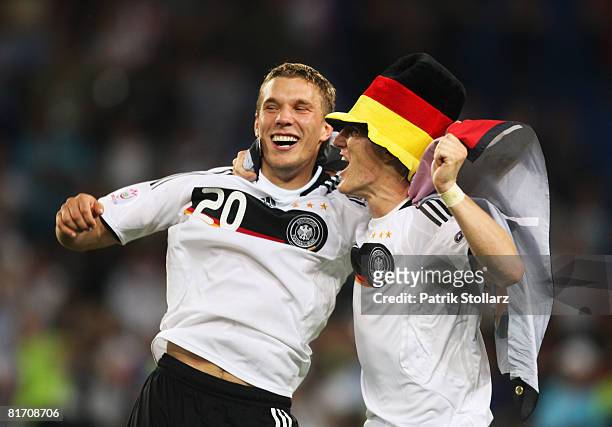 Bastian Schweinsteiger and team mate Lukas Podolski celebrate after the UEFA EURO 2008 Semi Final match between Germany and Turkey at St. Jakob-Park...