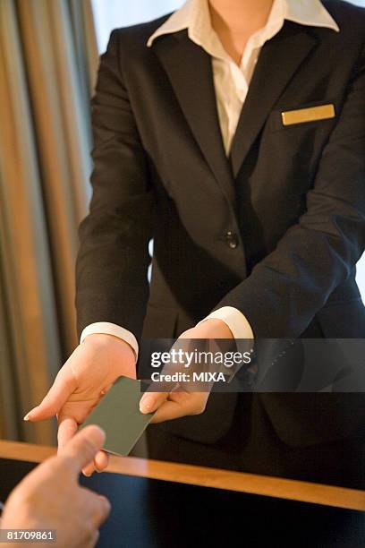 receptionist giving cardkey to hotel guest - hotel key stock pictures, royalty-free photos & images