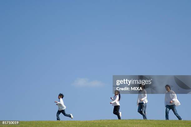 family running in field - 家族　日本人　走る ストックフォトと画像