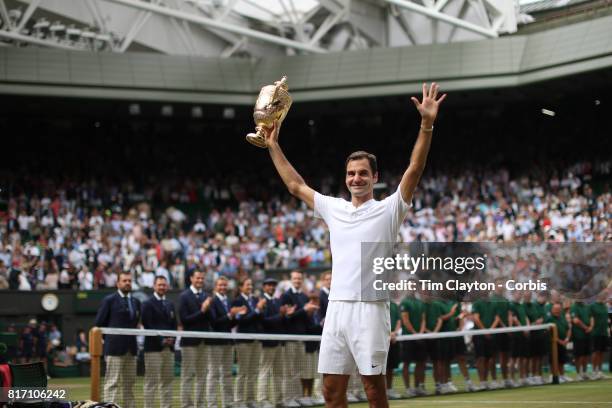 Roger Federer of Switzerland celebrates victory with the trophy after his win against against Marin Cilic of Croatia in the Gentlemen's Singles final...