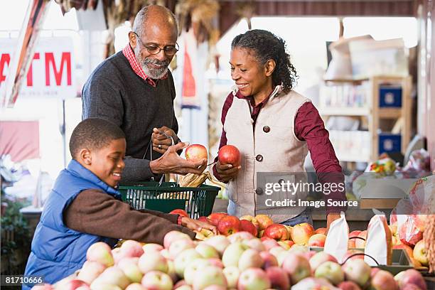 grandparents and their grandson choosing apples - choosing eyeglasses stock pictures, royalty-free photos & images