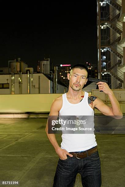 young man pointing a gun at his head - japanese mafia stock pictures, royalty-free photos & images