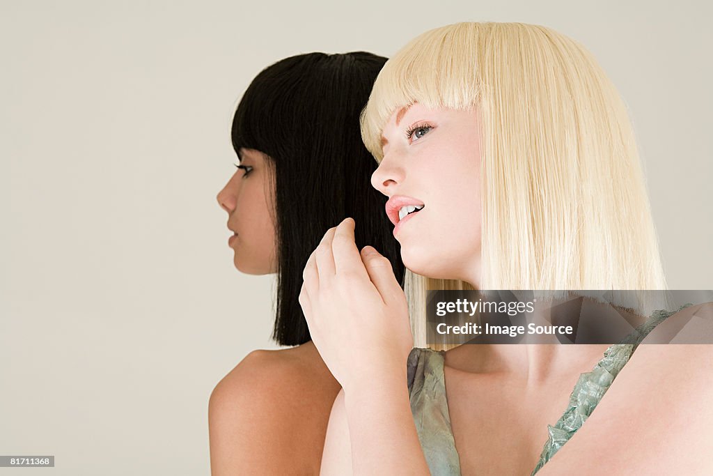 Young women whispering