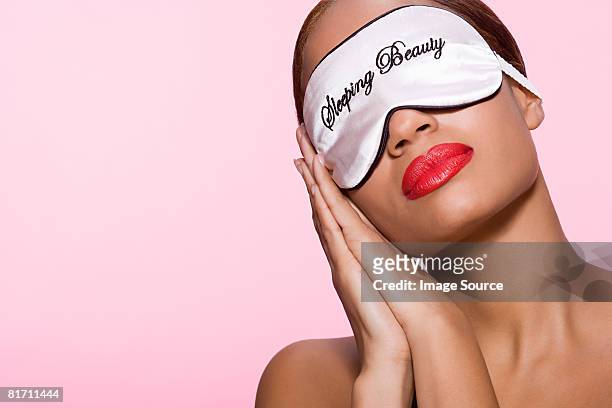 young woman wearing sleeping mask - beautiful woman sleeping stock pictures, royalty-free photos & images