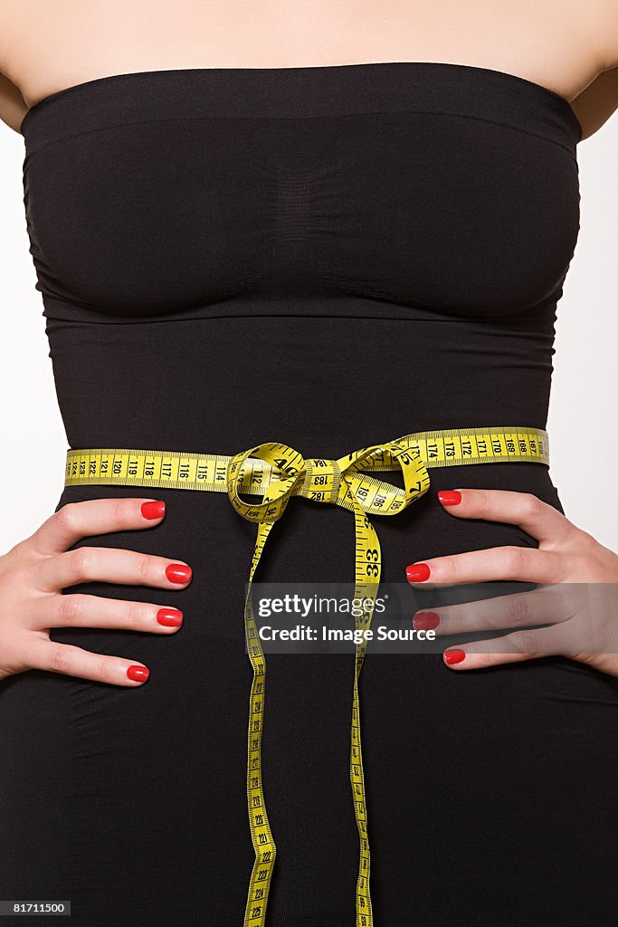 Woman with tape measure around her waist