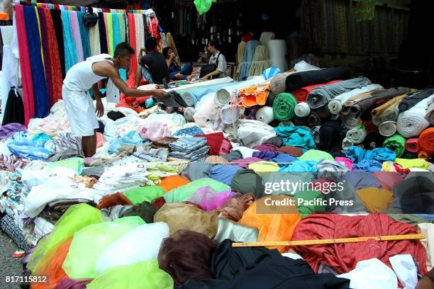 Sales person arranges the file of textile at Divisoria Market in Ylaya Street. Manila City. Divisoria Market is the heaven place for all dress...