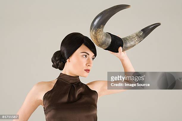 young woman with animal horn - bull photos et images de collection