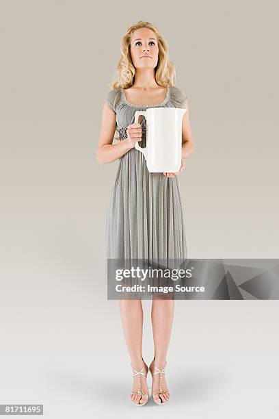 young woman holding jug - verseau photos et images de collection