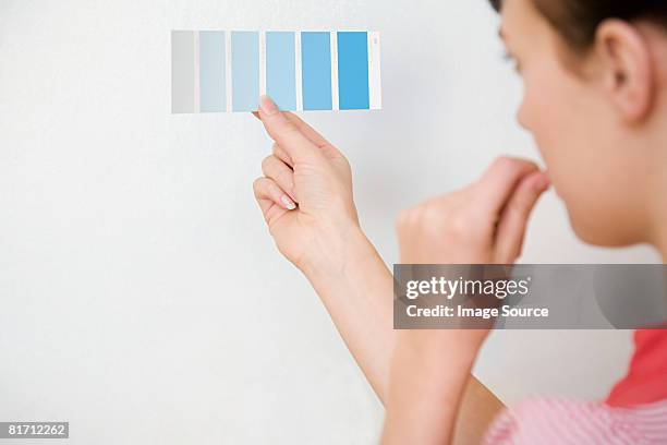 young woman holding colour chart - choosing paint stock pictures, royalty-free photos & images