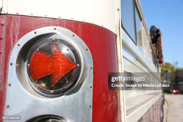 right arrow-shaped tail light signal of red bus - car blinker stock pictures, royalty-free photos & images