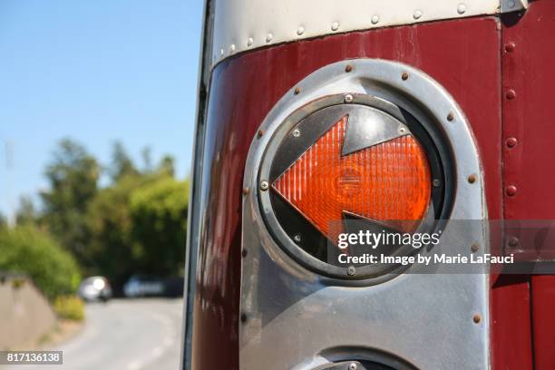 left arrow-shaped tail light signal of red bus - car blinker stock pictures, royalty-free photos & images
