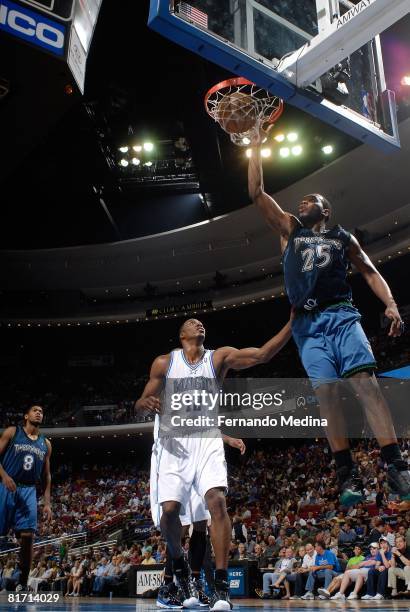 Al Jefferson of the Minnesota Timberwolves completes the dunk against Dwight Howard of the Orlando Magic during the game on April 11, 2008 at Amway...