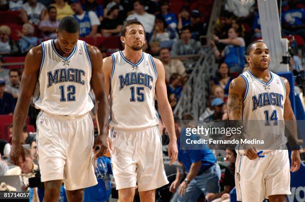 Dwight Howard, Hedo Turkoglu and Jameer Nelson of the Orlando Magic walk on the court during the game against the Minnesota Timberwolves on April 11,...