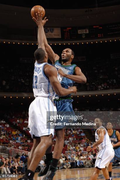 Al Jefferson of the Minnesota Timberwolves puts up a shot under pressure against Dwight Howard of the Orlando Magic during the game on April 11, 2008...