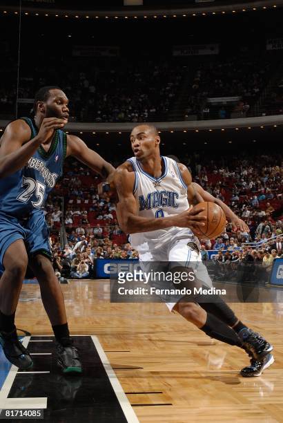 Rashard Lewis of the Orlando Magic drives to the basket under pressure against Al Jefferson of the Minnesota Timberwolves during the game on April...