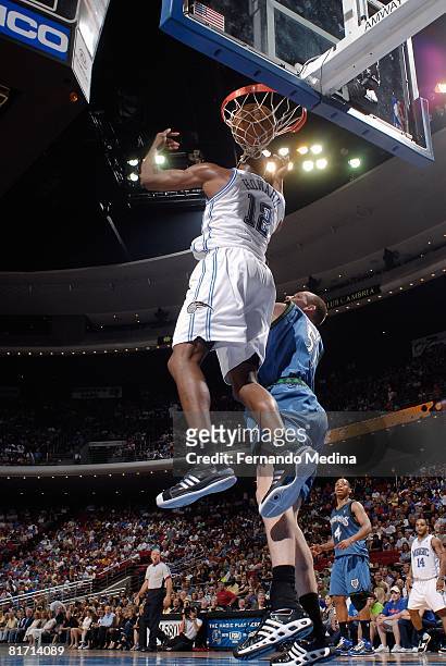 Dwight Howard of the Orlando Magic completes the reverse dunk against Michael Doleac of the Minnesota Timberwolves during the game on April 11, 2008...