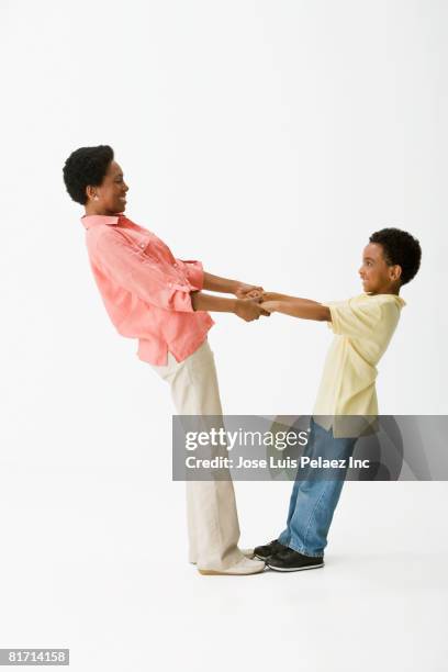 african mother and son holding hands - man and woman holding hands profile stock-fotos und bilder