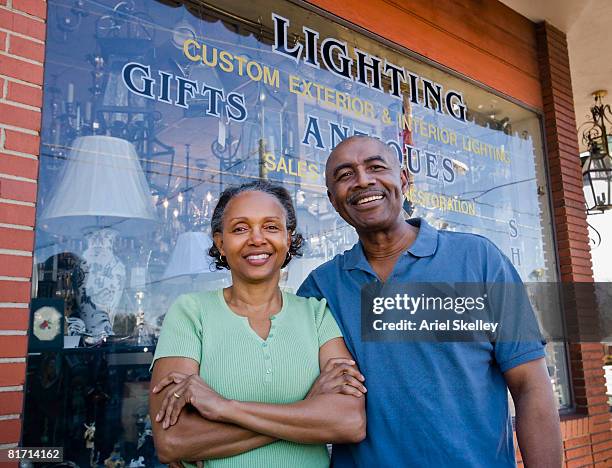 senior african couple in front of business - small town community stock pictures, royalty-free photos & images