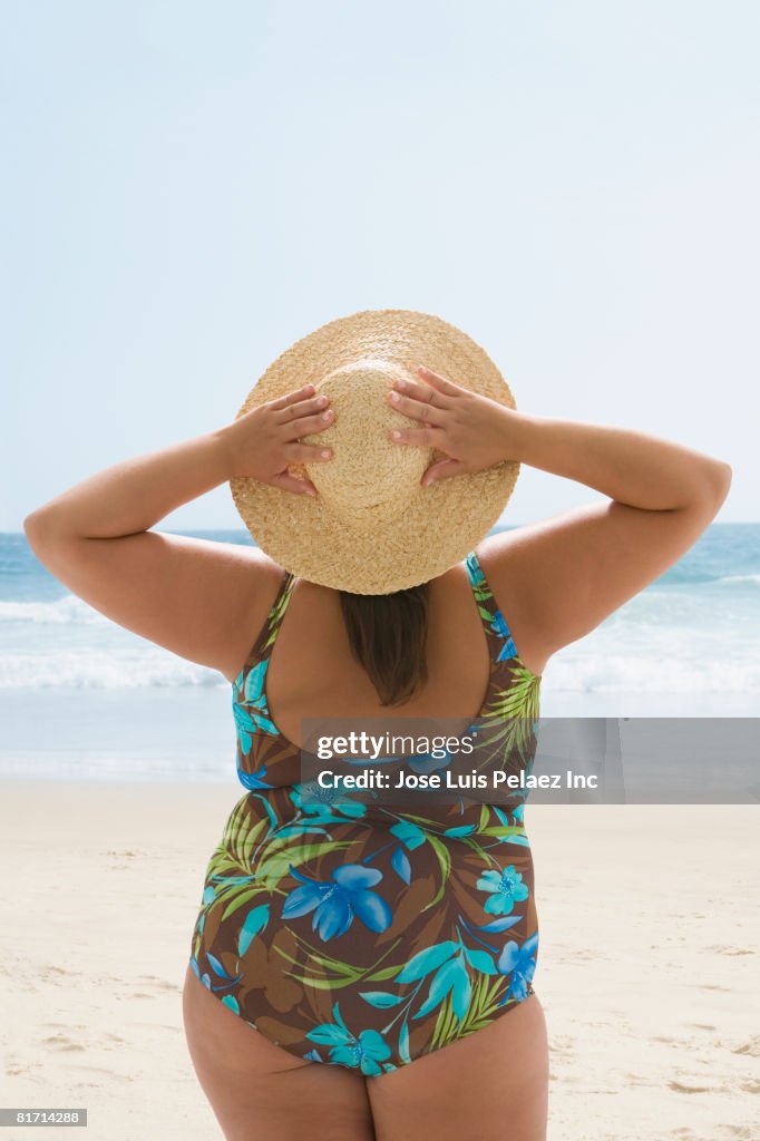 Overweight Hispanic woman at beach