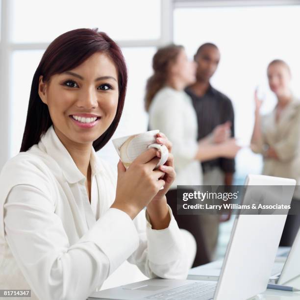 asian businesswoman holding coffee mug - cambodian ethnicity stock pictures, royalty-free photos & images