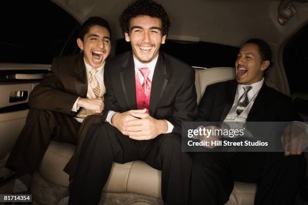 multi-ethnic teenaged boys laughing in limousine - prom limousine stock pictures, royalty-free photos & images