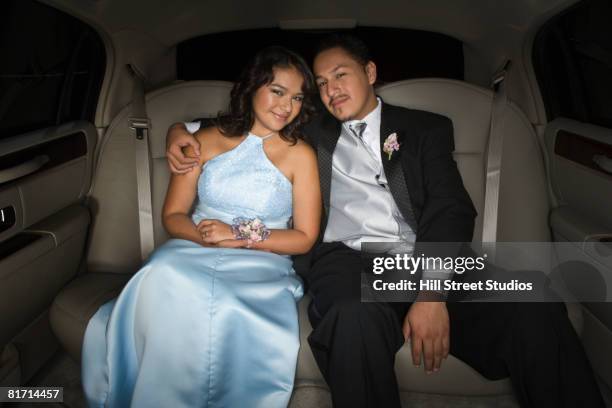 hispanic teenaged couple hugging in limousine - prom limousine stock pictures, royalty-free photos & images