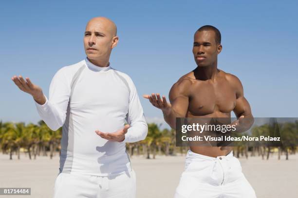 multi-ethnic men practicing yoga - glatzenbildung stock-fotos und bilder