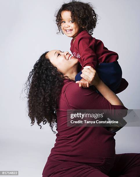 pregnant mixed race mother hugging son - asian pregnant woman white background photos et images de collection