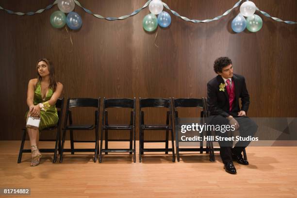 multi-ethnic teenagers sitting apart at prom - shy teen stock pictures, royalty-free photos & images